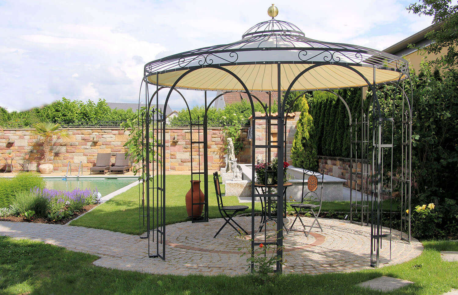 'Pavillon Florenz mit Messingkugel und Sonnensegel in pulverbeschichteter Ausführung in einem schönen Garten mit Pool'